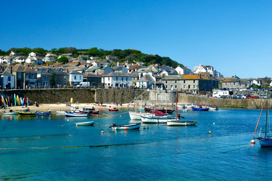 Mousehole harbour on a clear day.